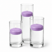 Three lit purple floating candles in clear glass cylinders - thumbnail number 1