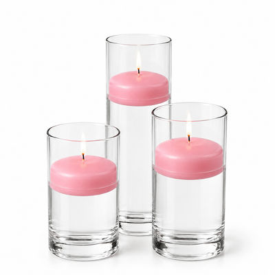 Three pink floating candles lit in glass cylinders - thumbnail number 1
