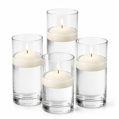 Tall glass cylinders filled with water and lit light ivory floating candles - thumbnail number 1