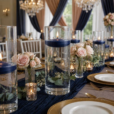Glass cylinders with floating navy blue candles and pink roses on a banquet table - thumbnail number 5