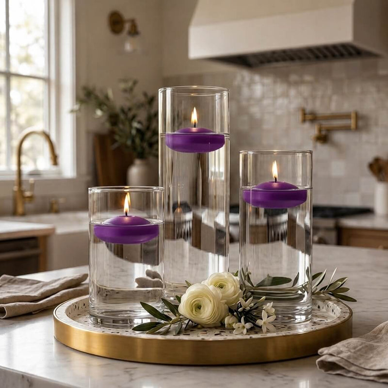 Three glass cylinder vases with lit purple floating candles on a tray with white flowers in a kitchen - thumbnail number 7