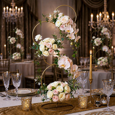 Gold 4-tier hoop stand adorned with blush roses, orchids, and greenery on a wedding table - thumbnail number 8