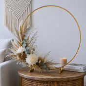 Gold hoop centerpiece with dried pampas grass and white flowers on a boho table - thumbnail number 9