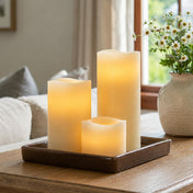 Flameless LED wavy-top pillar candles glowing on a wooden tray indoors - thumbnail number 7