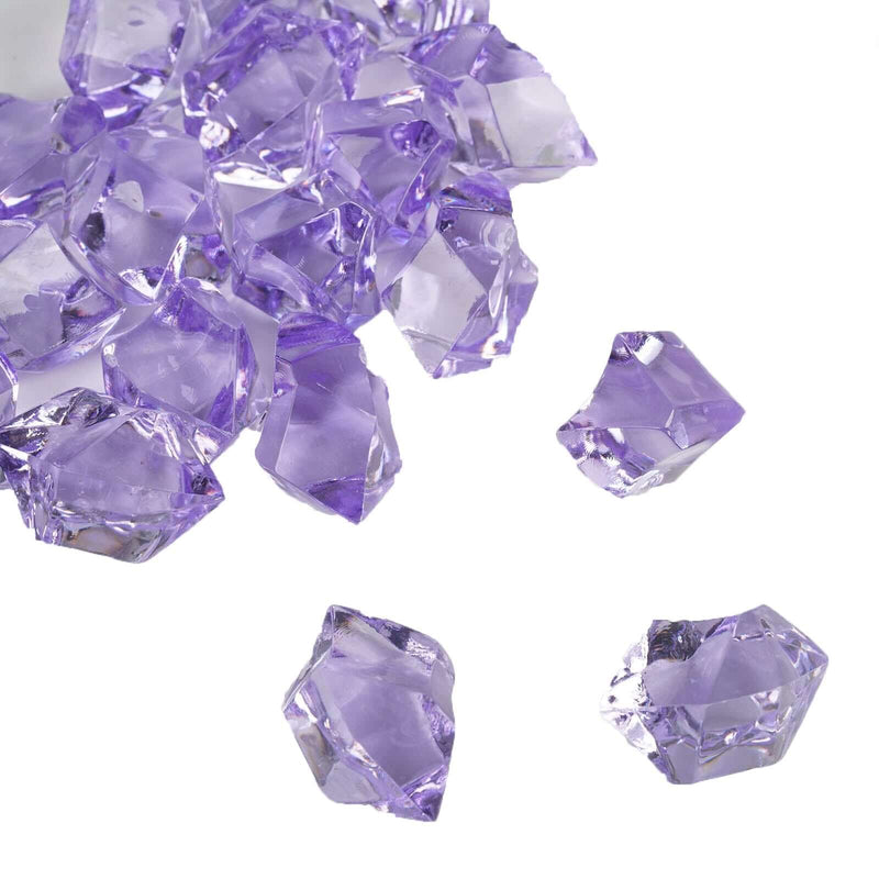 A cluster of large, faceted lavender acrylic ice bead vase fillers on a white background. - thumbnail number 1