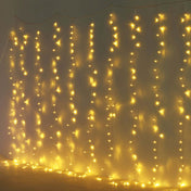 Warm white LED curtain string lights hanging vertically against a plain wall - thumbnail number 1
