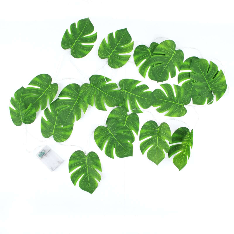 Artificial monstera leaf garland with warm white LED string lights on a white background - thumbnail number 1