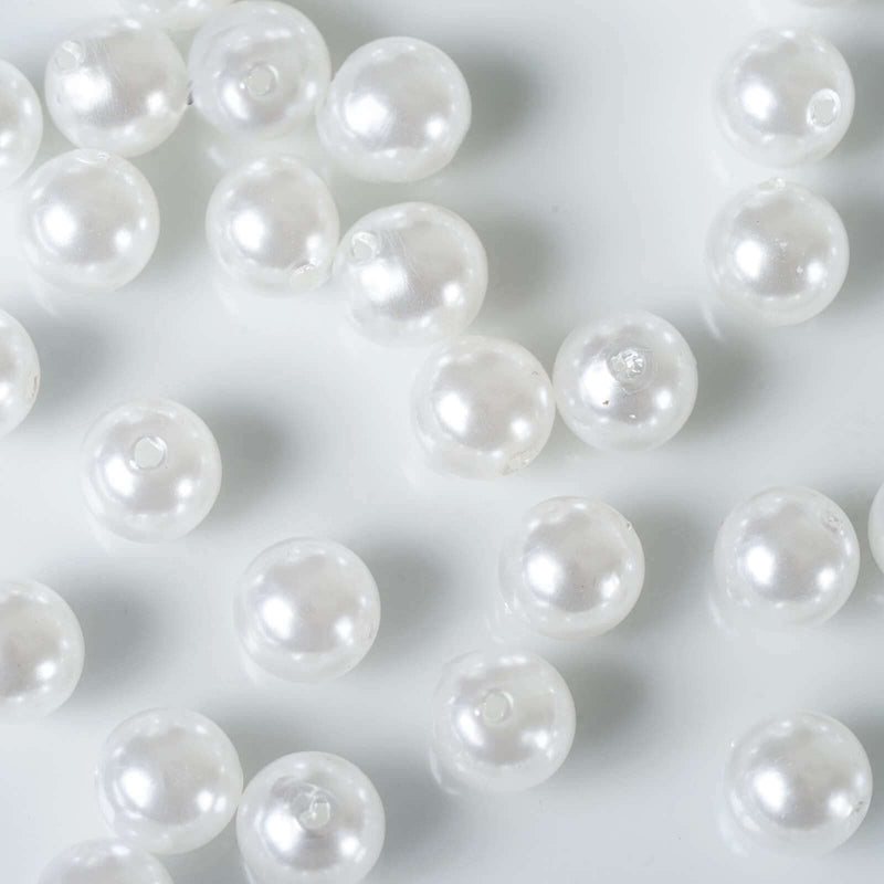 Scattered glossy white faux pearl vase fillers on white backdrop - thumbnail number 1