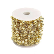 Gold faux pearl bead string vase filler spool on white background - thumbnail number 1