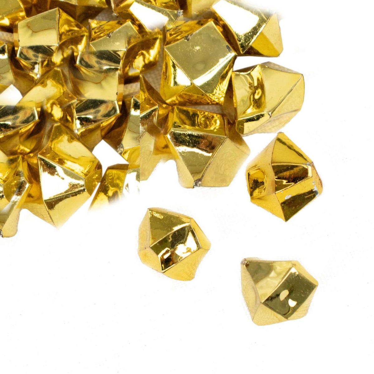Gold acrylic vase filler crystals scattered on white background