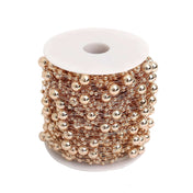 Rose gold faux pearl string beads vase filler spool on white background - thumbnail number 1